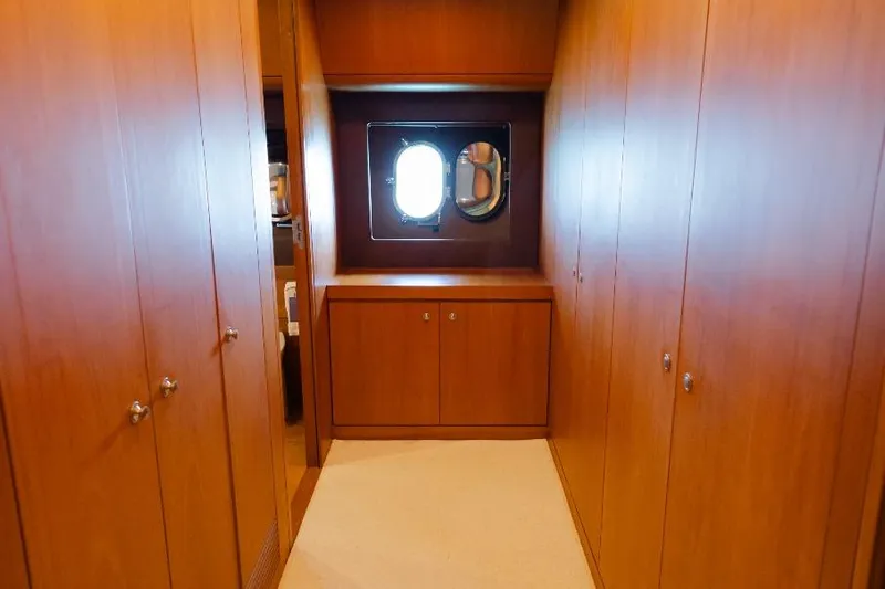 Mare Blu Yacht Photos Pics Luxurious wooden interior of 2008 Pro Boat Yachts Power Cat 80 with porthole window.