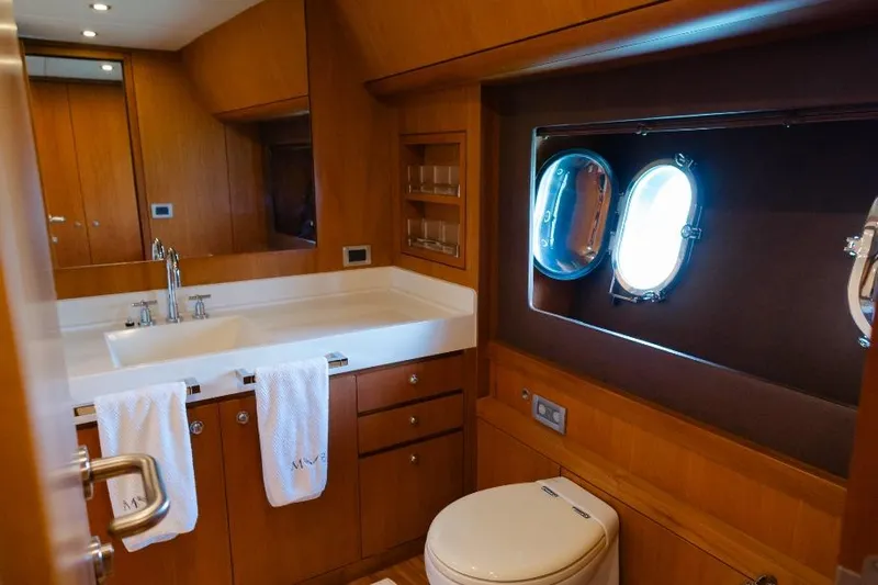 Mare Blu Yacht Photos Pics Luxurious bathroom interior of 2008 Pro Boat Yachts Power Cat 80 with porthole window.