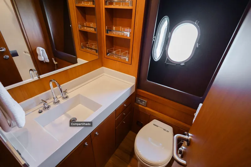 Mare Blu Yacht Photos Pics Luxurious bathroom in 2008 Pro Boat Yachts Power Cat 80, featuring modern fixtures and porthole window.