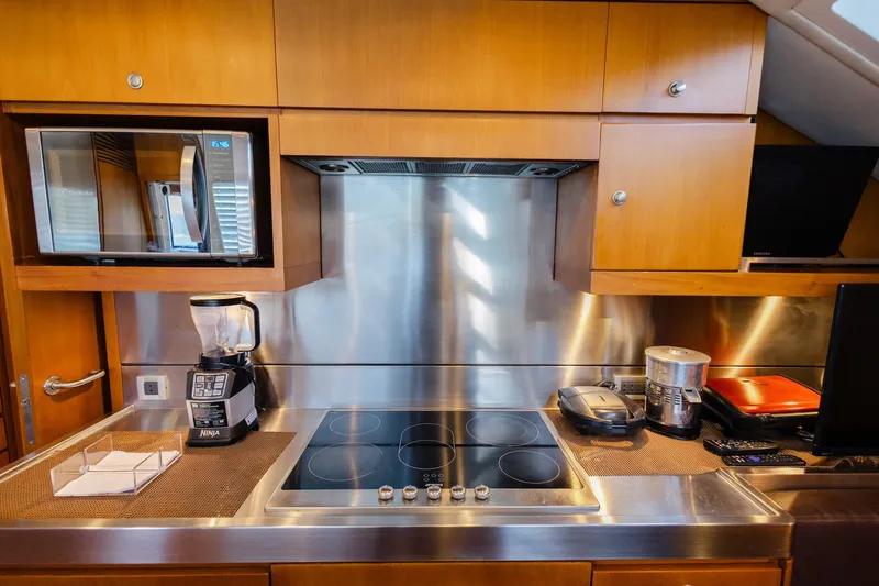 Mare Blu Yacht Photos Pics Modern kitchen in 2008 Pro Boat Yachts Power Cat 80 with appliances and wooden cabinetry.