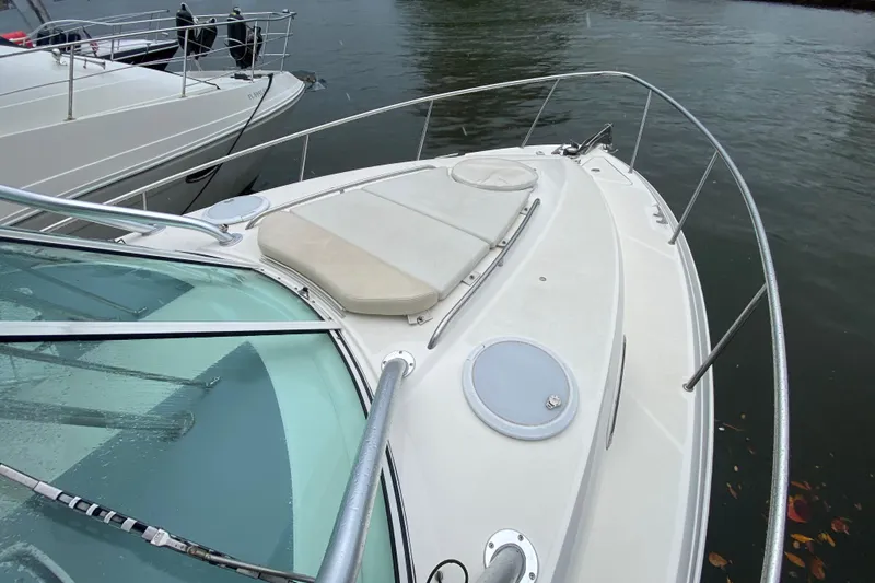  Yacht Photos Pics 2014 Wellcraft 340 Coastal boat deck with railing, docked on calm water.