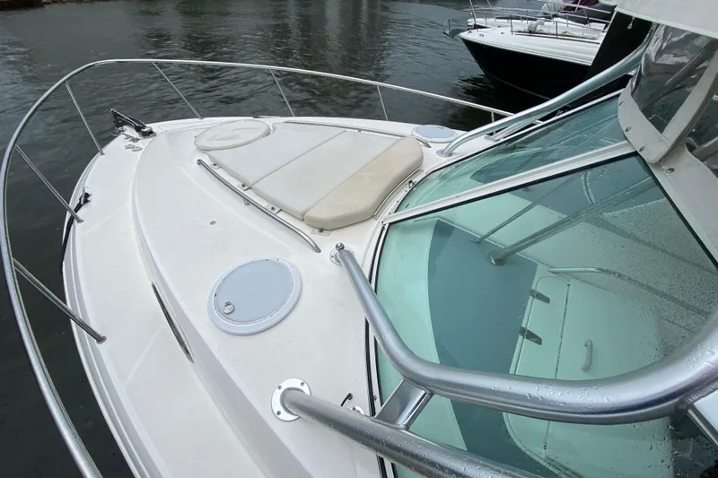  Yacht Photos Pics 2014 Wellcraft 340 Coastal boat deck with seating, docked on calm water.