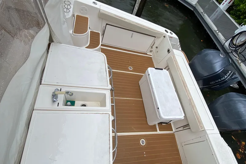  Yacht Photos Pics 2014 Wellcraft 340 Coastal boat deck with Yamaha engines and storage compartments.