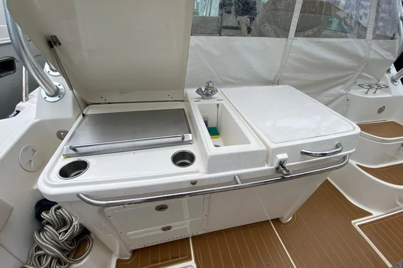  Yacht Photos Pics 2014 Wellcraft 340 Coastal boat interior with sink and storage area.