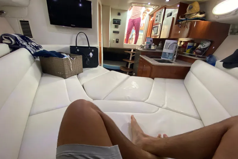  Yacht Photos Pics Interior of 2014 Wellcraft 340 Coastal boat with white seating and kitchenette.