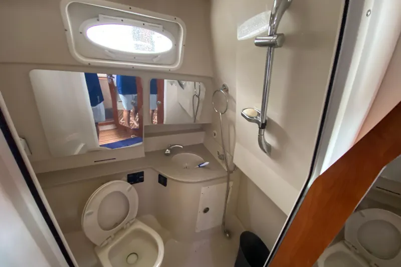  Yacht Photos Pics 2014 Wellcraft 340 Coastal boat bathroom with shower, sink, and toilet.