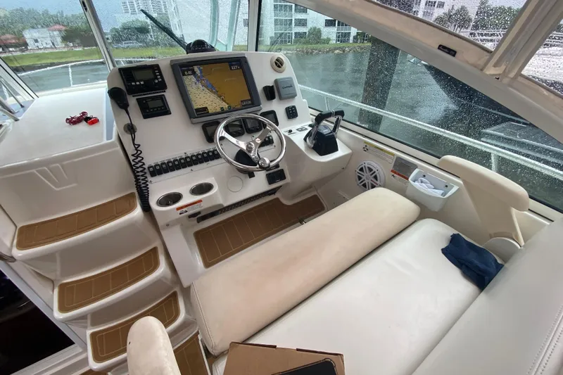  Yacht Photos Pics 2014 Wellcraft 340 Coastal boat cockpit with navigation system and steering wheel.