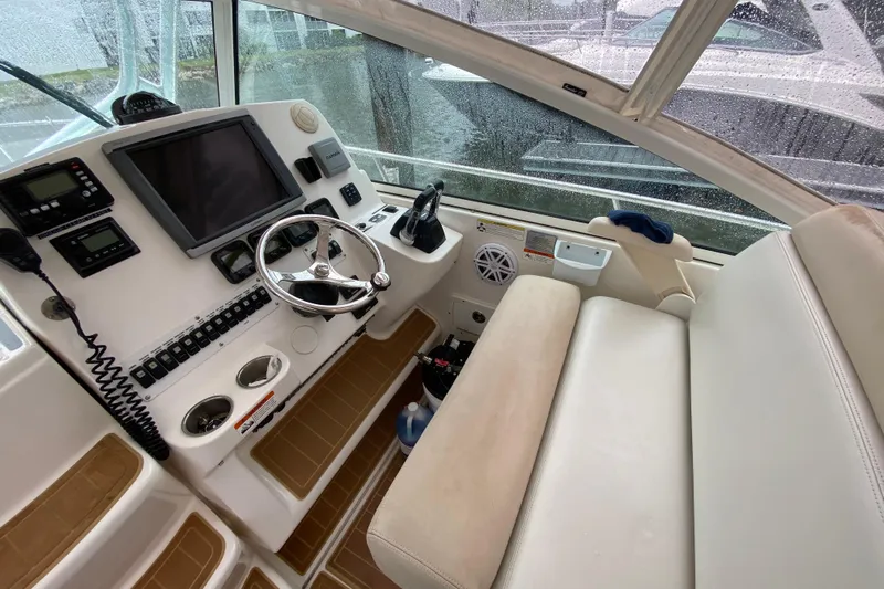  Yacht Photos Pics 2014 Wellcraft 340 Coastal boat cockpit with steering wheel and navigation equipment.