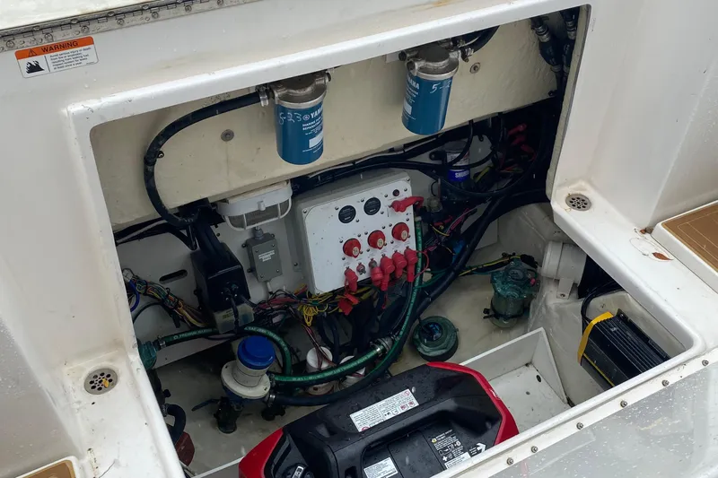  Yacht Photos Pics Engine compartment of 2014 Wellcraft 340 Coastal boat, showcasing wiring and components.