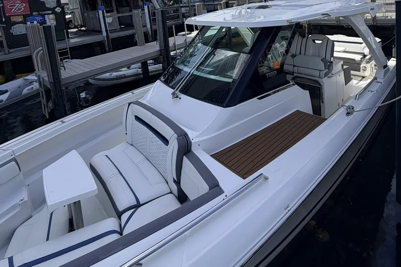 Yacht Photos Pics 2021 Tiara Sport 34 LS boat with sleek design and luxurious seating at a dock.