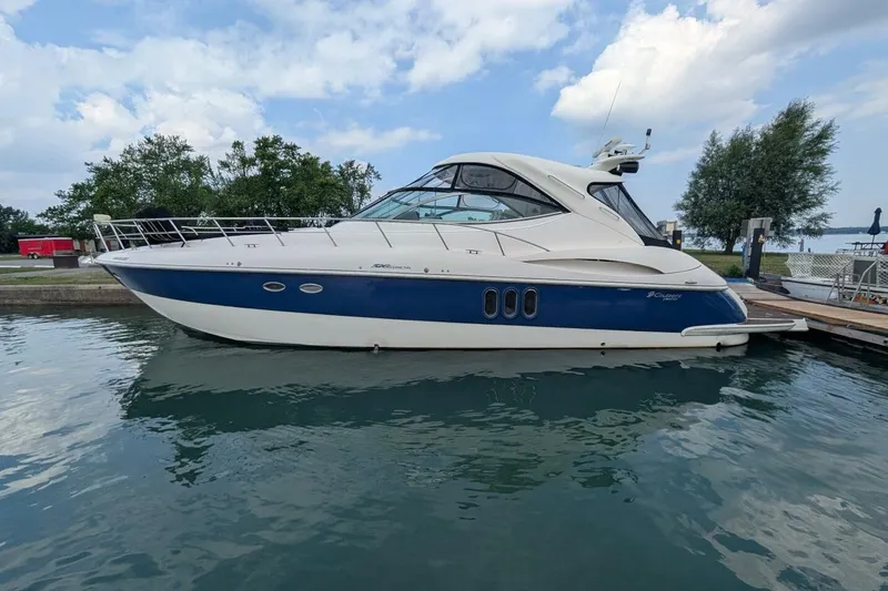  Yacht Photos Pics 2007 Cruisers Yachts 520 Express docked on calm water under a cloudy sky.