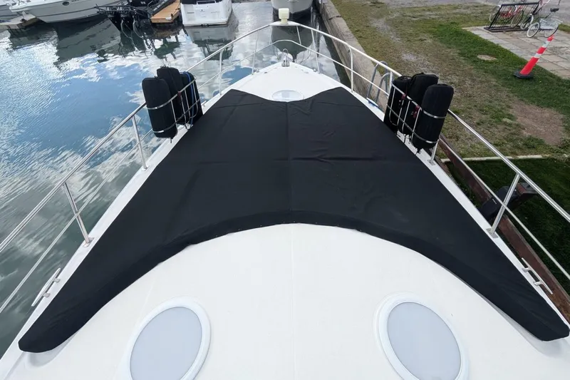  Yacht Photos Pics 2007 Cruisers Yachts 520 Express bow with black cover, docked at marina.