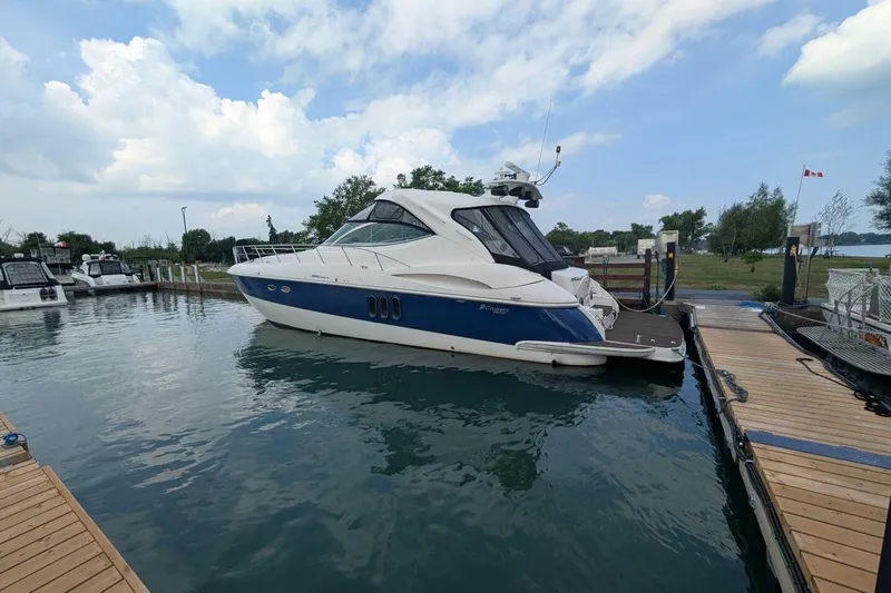  Yacht Photos Pics 2007 Cruisers Yachts 520 Express docked at a marina under a partly cloudy sky.