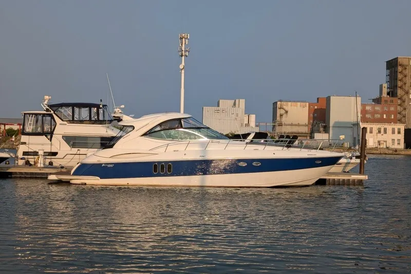  Yacht Photos Pics 2007 Cruisers Yachts 520 Express docked in a marina, with industrial buildings in the background.
