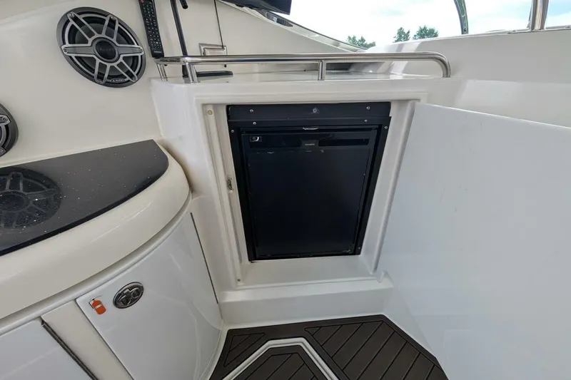  Yacht Photos Pics 2007 Cruisers Yachts 520 Express interior with built-in mini fridge and speakers.