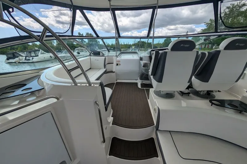  Yacht Photos Pics 2007 Cruisers Yachts 520 Express interior with seating and helm, docked by the water.