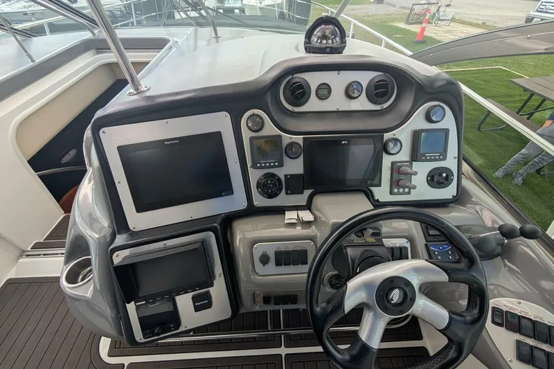  Yacht Photos Pics 2007 Cruisers Yachts 520 Express helm with advanced navigation controls and steering wheel.