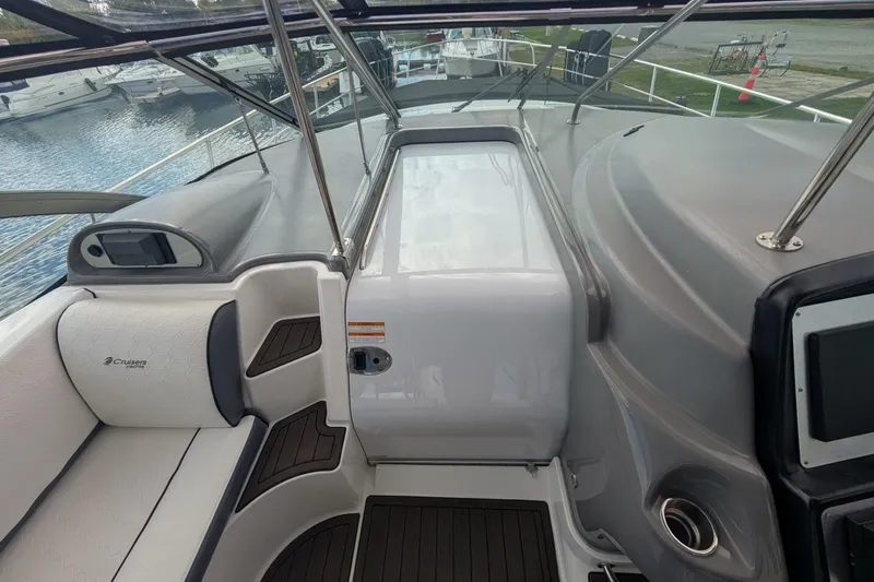  Yacht Photos Pics 2007 Cruisers Yachts 520 Express interior with seating and helm, docked by the water.