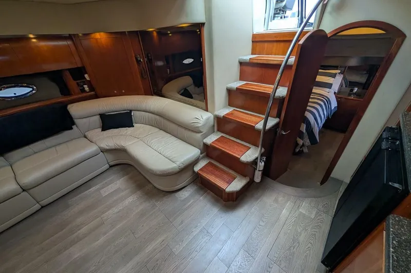  Yacht Photos Pics Luxurious interior of 2007 Cruisers Yachts 520 Express with elegant seating and wooden stairs.