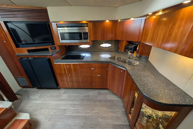  Yacht Photos Pics Luxurious 2007 Cruisers Yachts 520 Express kitchen with wood cabinetry and modern appliances.