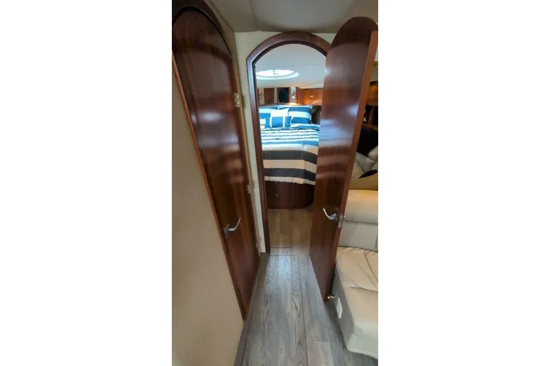  Yacht Photos Pics 2007 Cruisers Yachts 520 Express interior hallway leading to a cozy bedroom.