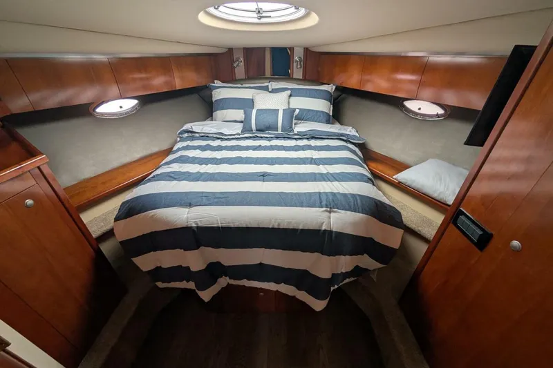  Yacht Photos Pics Luxurious cabin interior of 2007 Cruisers Yachts 520 Express with striped bedding.