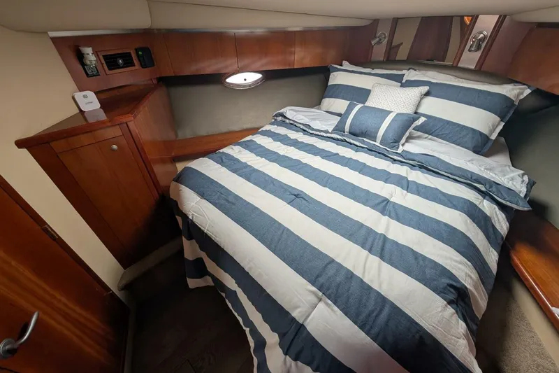  Yacht Photos Pics Luxurious cabin interior of 2007 Cruisers Yachts 520 Express with striped bedding.