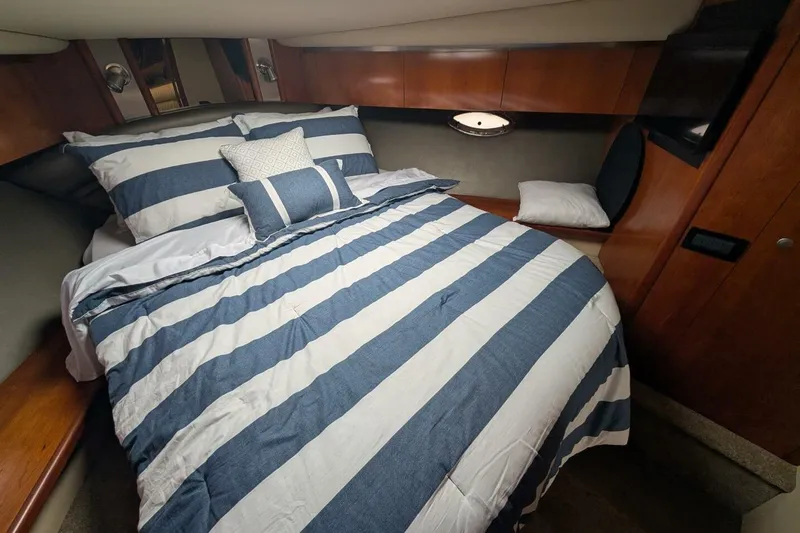  Yacht Photos Pics Luxurious cabin interior of 2007 Cruisers Yachts 520 Express with striped bedding.