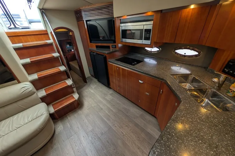  Yacht Photos Pics Luxurious 2007 Cruisers Yachts 520 Express interior with modern kitchen and elegant wood finishes.