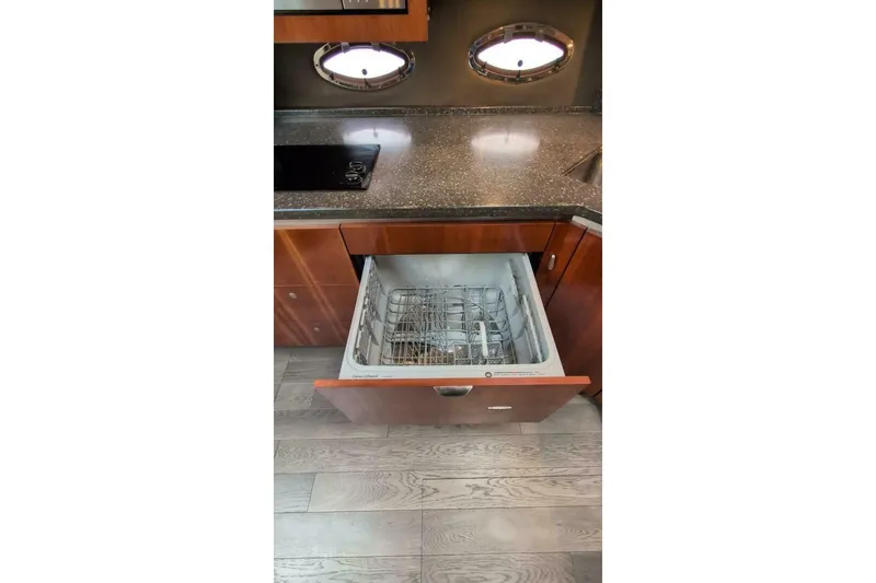  Yacht Photos Pics 2007 Cruisers Yachts 520 Express kitchen with open dishwasher drawer.