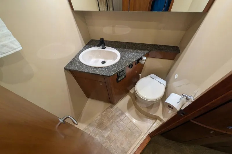  Yacht Photos Pics Luxurious bathroom in 2007 Cruisers Yachts 520 Express with modern fixtures and elegant design.