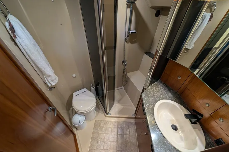  Yacht Photos Pics Luxurious bathroom in 2007 Cruisers Yachts 520 Express with shower, sink, and toilet.