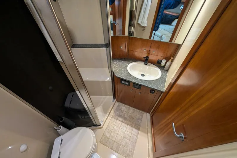  Yacht Photos Pics 2007 Cruisers Yachts 520 Express bathroom with sink, toilet, and wood cabinetry.