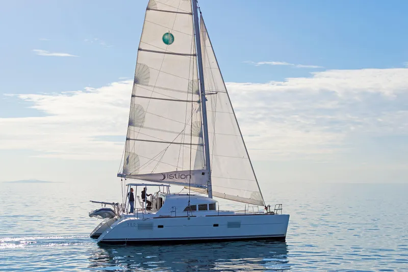 Cataki Yacht Photos Pics 2017 Lagoon 380 S2 catamaran sailing on calm blue waters under clear skies.
