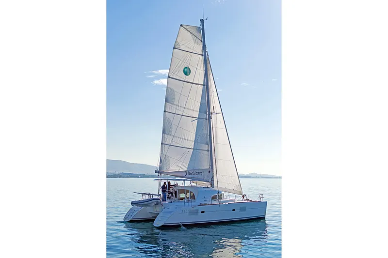 Cataki Yacht Photos Pics 2017 Lagoon 380 S2 catamaran sailing on calm waters under clear skies.
