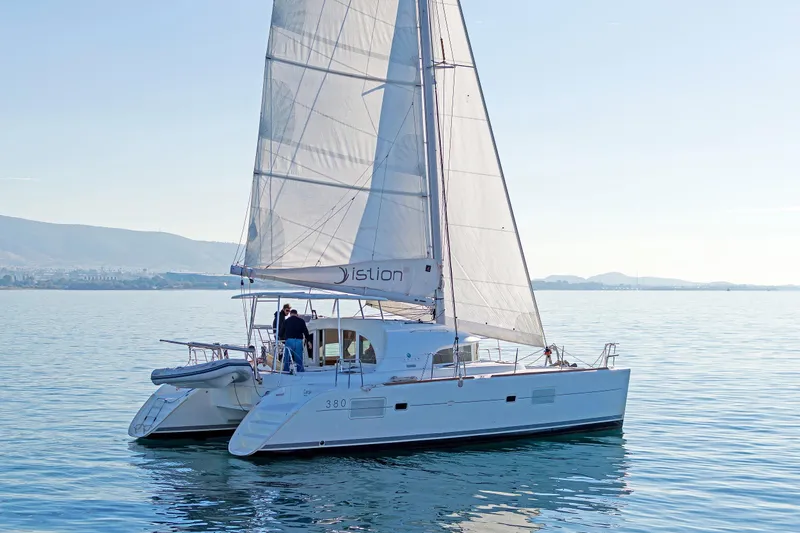 Cataki Yacht Photos Pics 2017 Lagoon 380 S2 catamaran sailing on calm waters under clear skies.