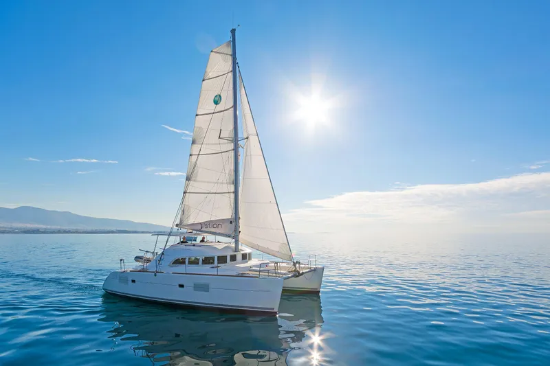 Cataki Yacht Photos Pics Sailing catamaran Lagoon 380 S2, 2017 model, gliding on calm sea under bright sun.