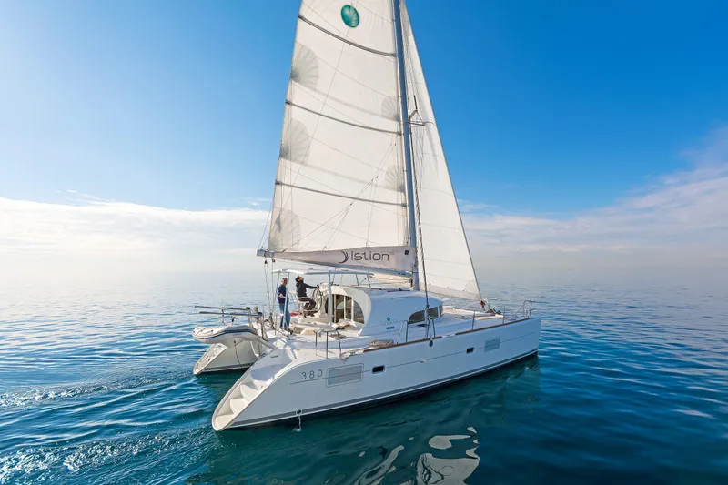 Cataki Yacht Photos Pics 2017 Lagoon 380 S2 catamaran sailing on calm blue waters under clear skies.