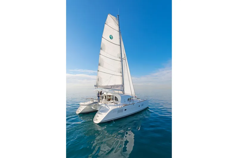 Cataki Yacht Photos Pics 2017 Lagoon 380 S2 catamaran sailing on calm blue waters under clear skies.