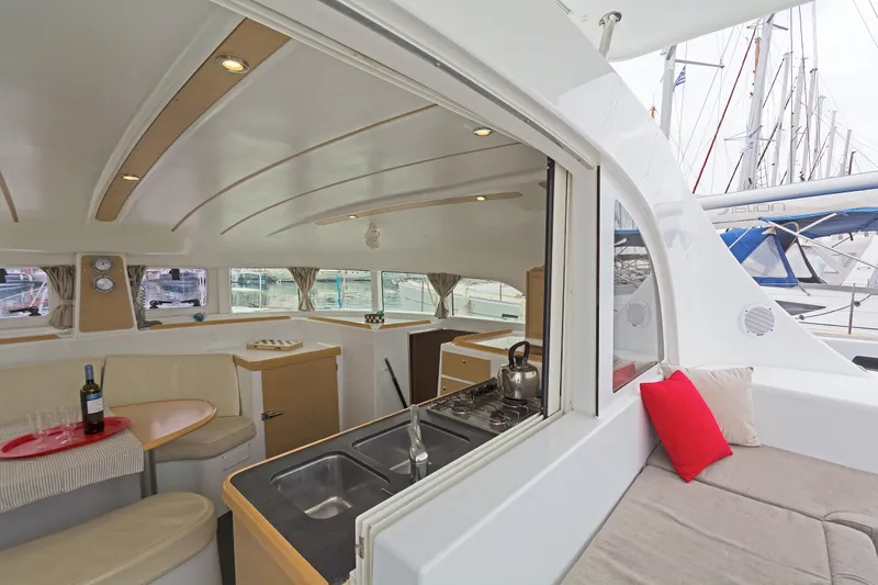 Cataki Yacht Photos Pics Interior of 2017 Lagoon 380 S2 catamaran with kitchen and seating area.