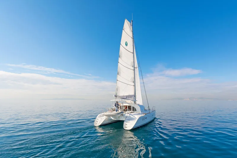 Cataki Yacht Photos Pics 2017 Lagoon 380 S2 catamaran sailing on calm blue ocean under clear sky.