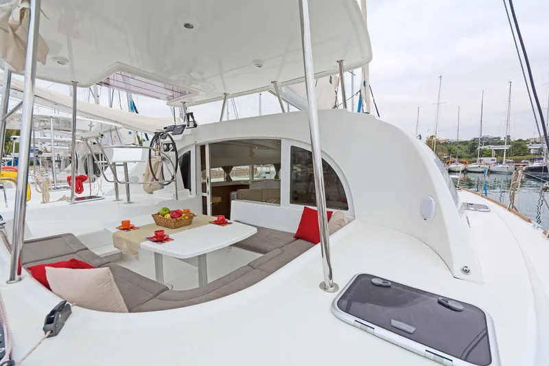 Cataki Yacht Photos Pics 2017 Lagoon 380 S2 catamaran with spacious deck and seating area in marina.