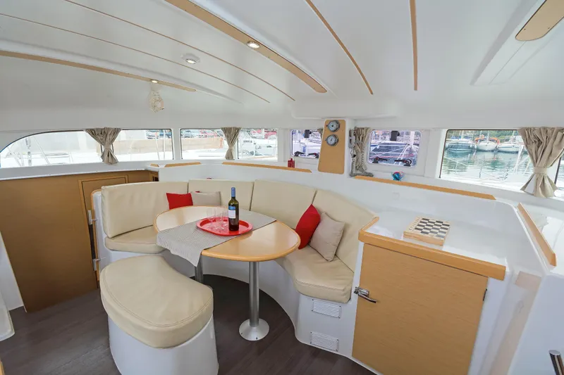 Cataki Yacht Photos Pics Luxurious interior of 2017 Lagoon 380 S2 catamaran with cozy seating and elegant decor.