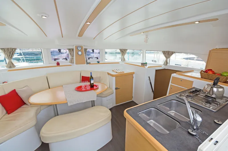 Cataki Yacht Photos Pics Interior of 2017 Lagoon 380 S2 catamaran with modern kitchen and cozy seating area.