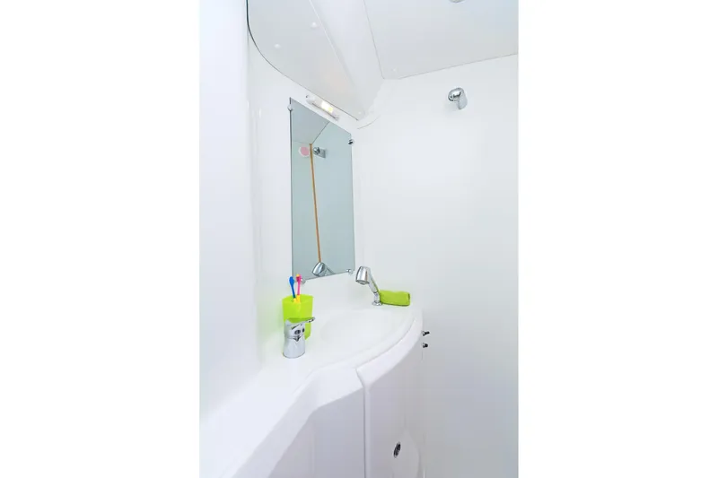 Cataki Yacht Photos Pics Bathroom interior of 2017 Lagoon 380 S2 catamaran with sink and mirror.