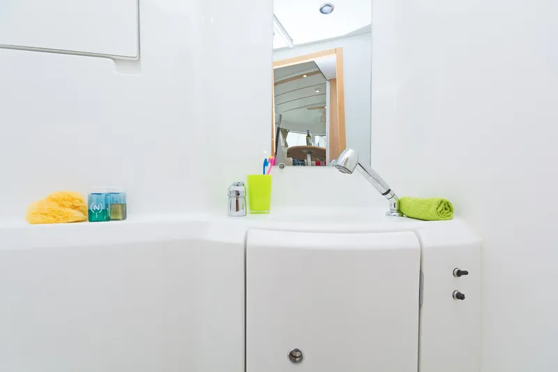 Cataki Yacht Photos Pics Bathroom sink area on 2017 Lagoon 380 S2 yacht with toiletries and mirror.