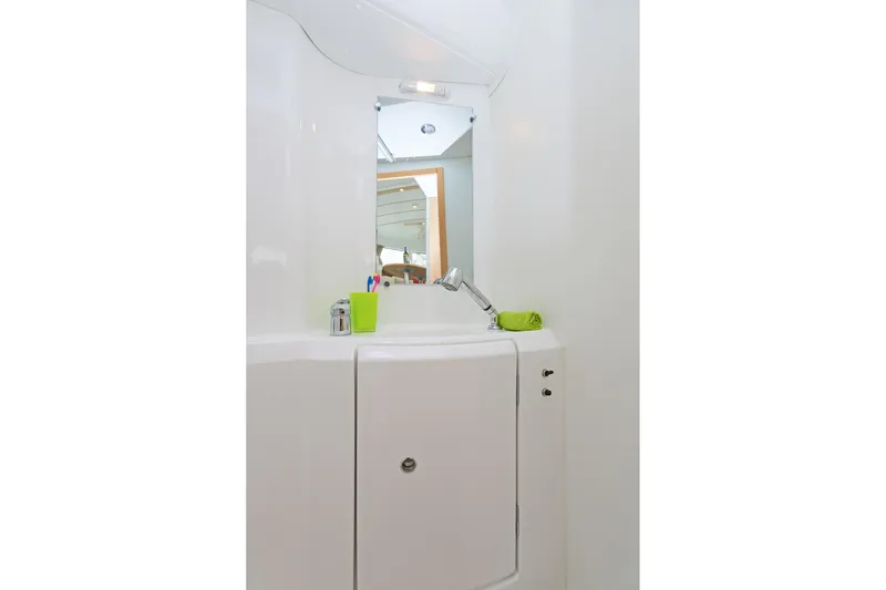 Cataki Yacht Photos Pics Bathroom interior of 2017 Lagoon 380 S2 yacht with mirror and sink.
