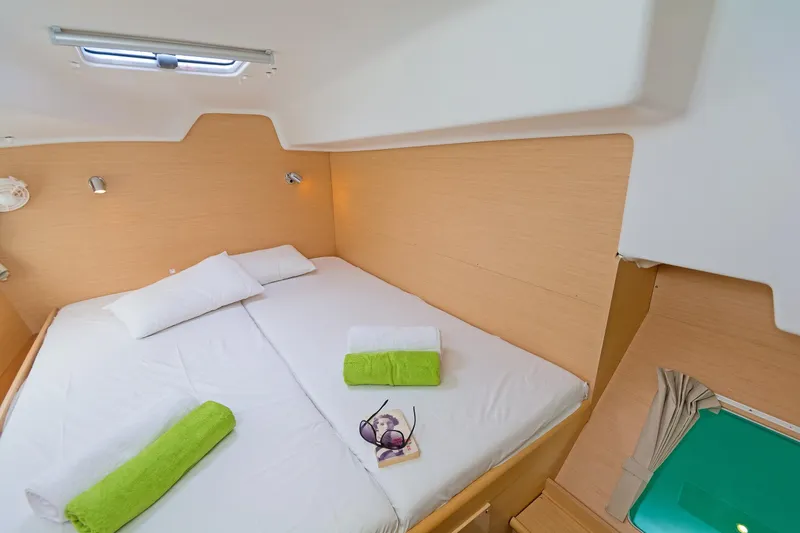 Cataki Yacht Photos Pics Cozy cabin interior of 2017 Lagoon 380 S2 catamaran with neatly arranged bed.