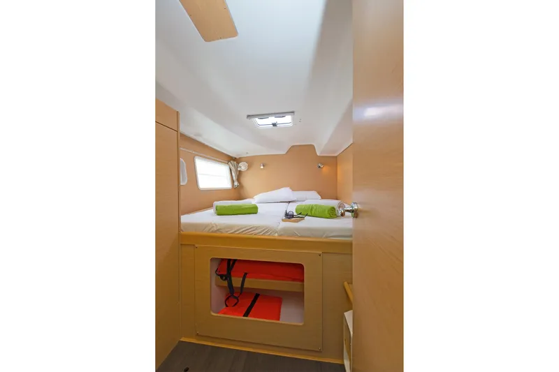 Cataki Yacht Photos Pics Cozy cabin interior of 2017 Lagoon 380 S2 catamaran with bed and porthole window.