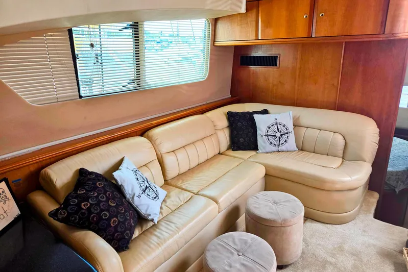  Yacht Photos Pics Luxurious 2003 Silverton 392 Motor Yacht interior with beige leather seating and nautical-themed pillows.